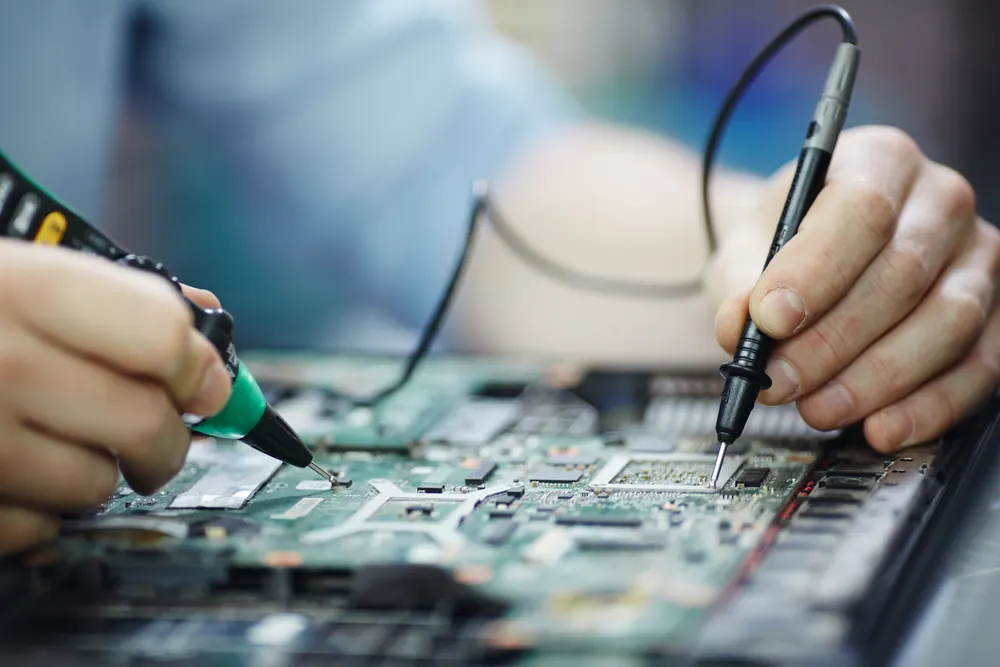 IT support technician working on a laptop